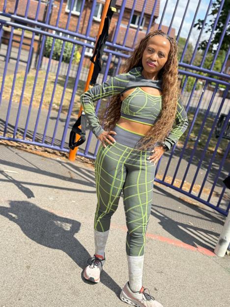 Charmaine Masoeu wearing an olive green and neon yellow athletic outfit with a sports bra, cropped long-sleeved shirt, and leggings.