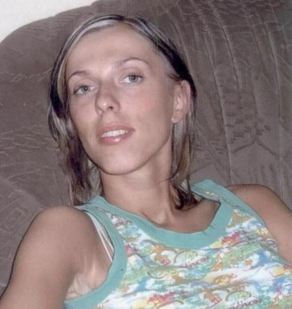 Malgorzata Wnuczek, a woman with blonde highlights in her hair, wearing a teal and white patterned tank top.