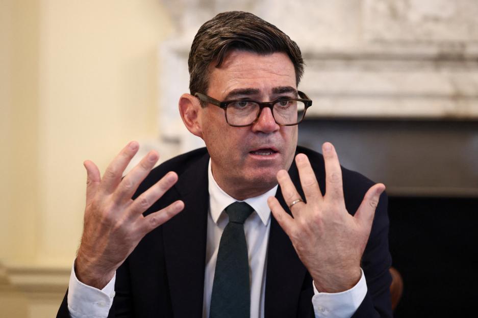 Andy Burnham speaking, gesturing with both hands.