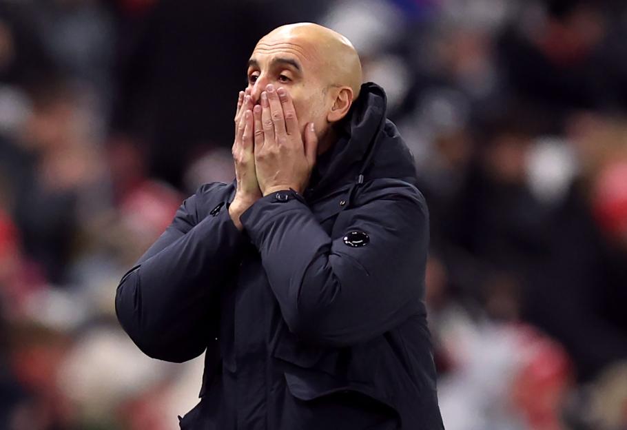 Pep Guardiola, Manager of Manchester City, reacts during a soccer match.