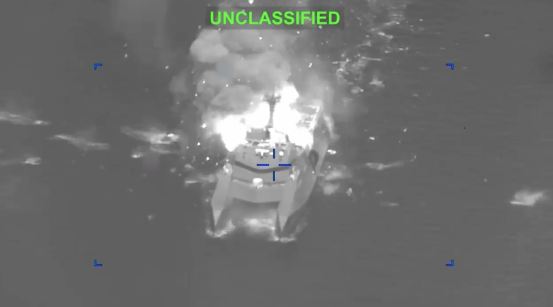 Thermal image of a naval vessel being hit with an explosion, overlaid with targeting reticles and the word "UNCLASSIFIED."