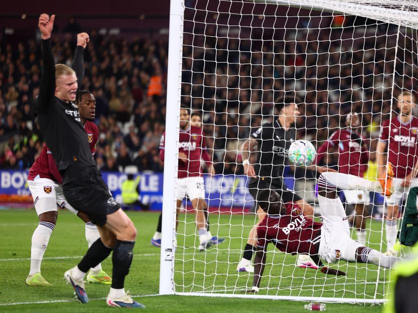 London, UK. 14th Mar, 2026. El Hadji Malick Diouf of West Ham United fails to see out a shot from Bernardo Silva (not pictured) of Manchester City who scores to make it 1-0 as Erling Haaland of Manchester City celebrates during the West Ham United vs