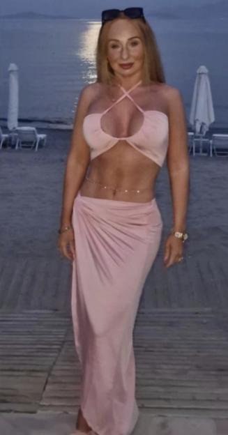 Debbie Brannan posing on a beach.