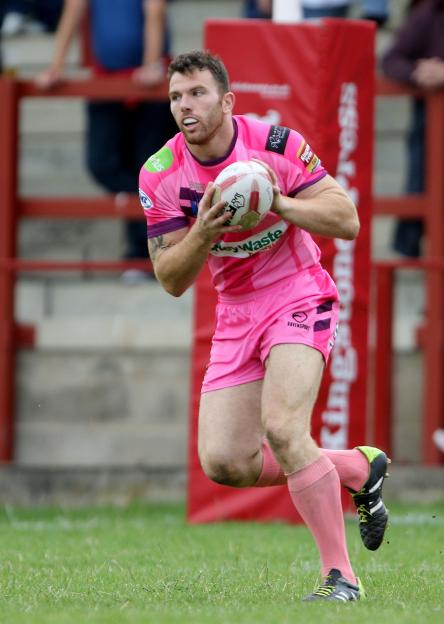 Keegan Hirst running with a rugby ball.