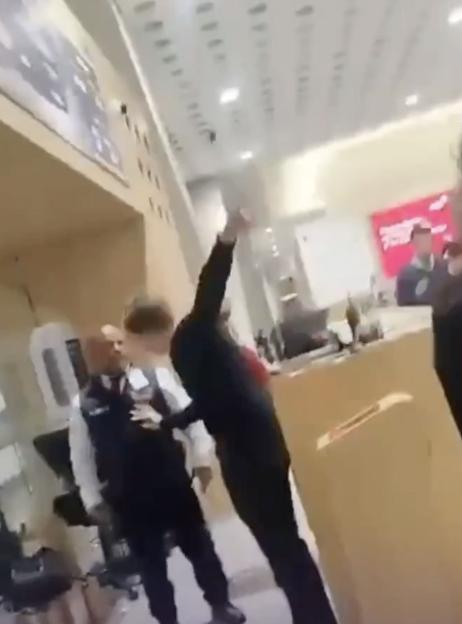 VIDEO: Passengers 'attack' airport staff in shocking brawl after being thrown off plane for alleged drunken rampage