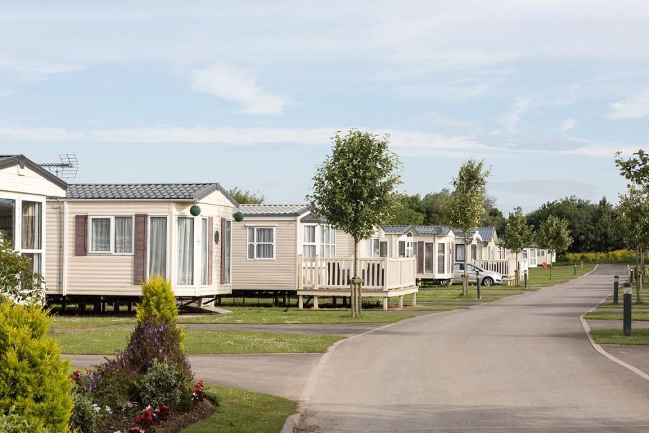 A row of static caravans in a park setting.