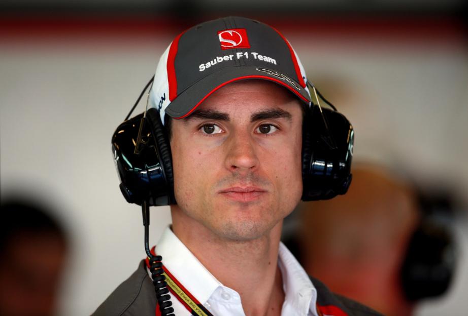 Headshot of Sauber's Adrian Sutil wearing a team hat and headphones.