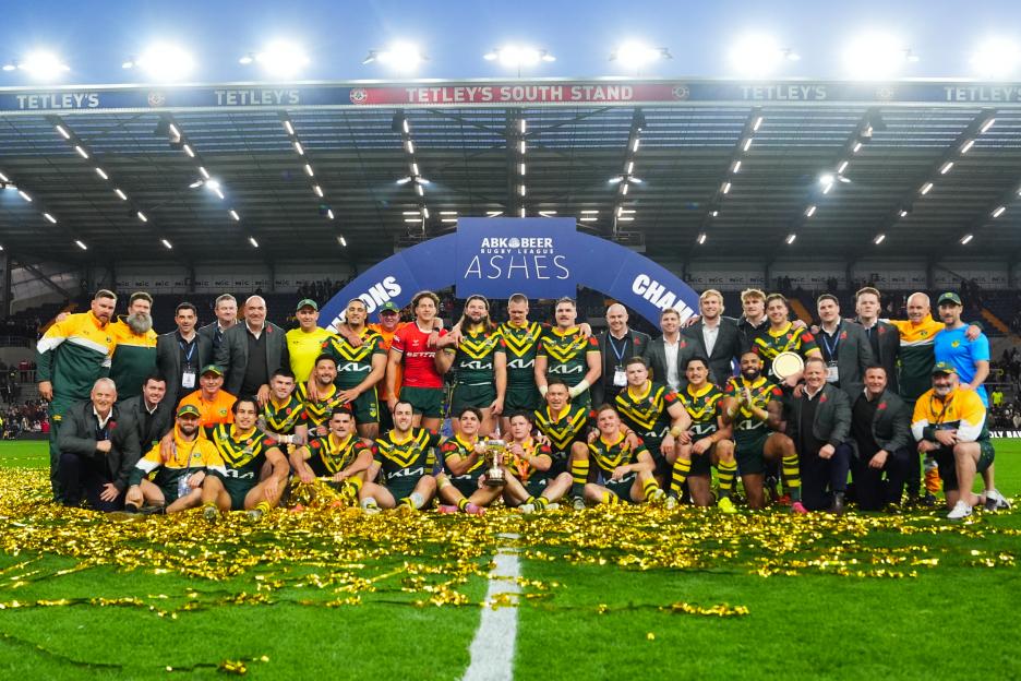 The Australian rugby league team celebrating their victory in the Ashes, surrounded by gold confetti.