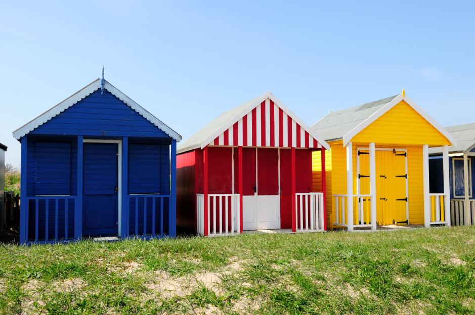 Three colorful beach huts in Mablethorpe, Lincolnshire.
