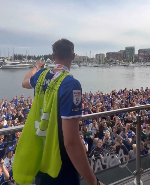 Athlete celebrating victory with fans.