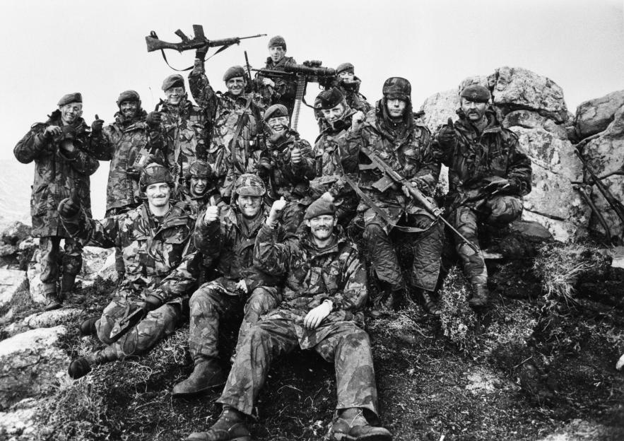 Black and white photo of 7 Platoon, G Company, 2nd Battalion Scots Guards celebrating the Argentine surrender.