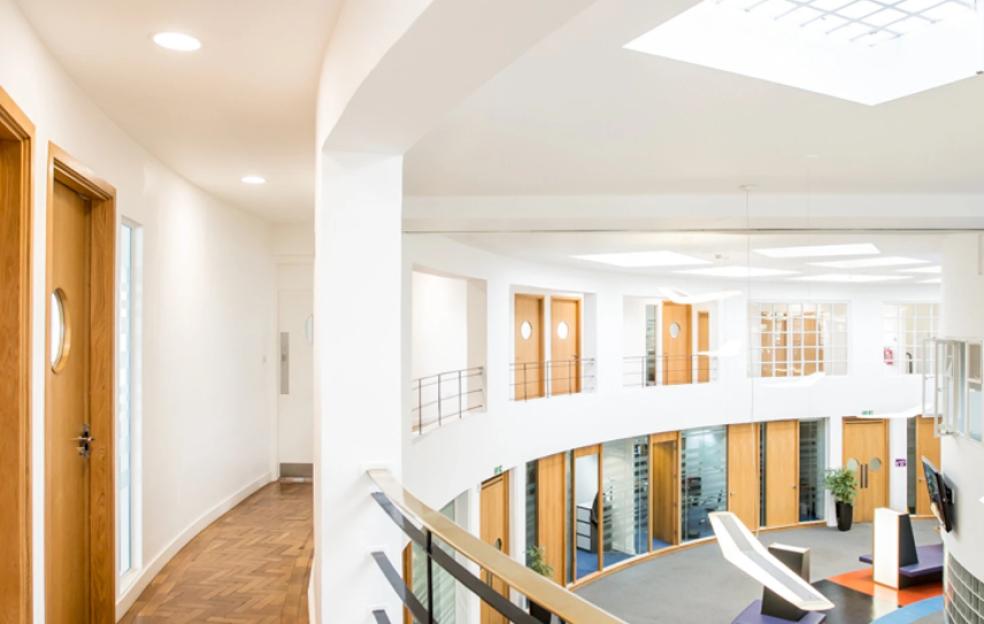 The interior of The Beehive, the original terminal building at Gatwick Airport, showing two levels of offices and a circular open space.