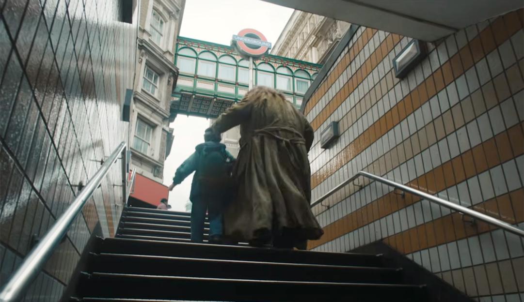 Harry Potter and Hagrid climbing stairs out of a London Underground station.