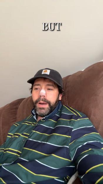 Charlie King, former TOWIE star, with white cream on his nose, looking concerned while wearing a striped shirt and a baseball cap.