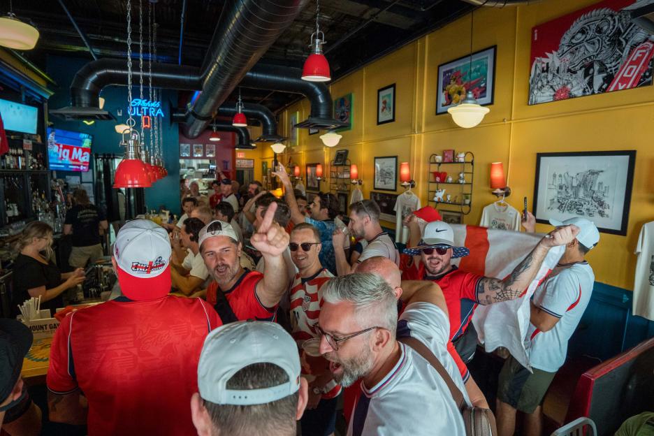 English fans chant in a pub before the FIFA World Cup 2026 Round of 32 match.