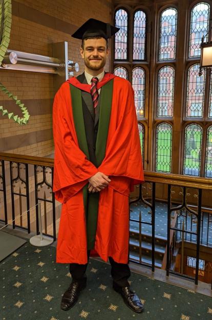 Tom Davies in graduation robes.
