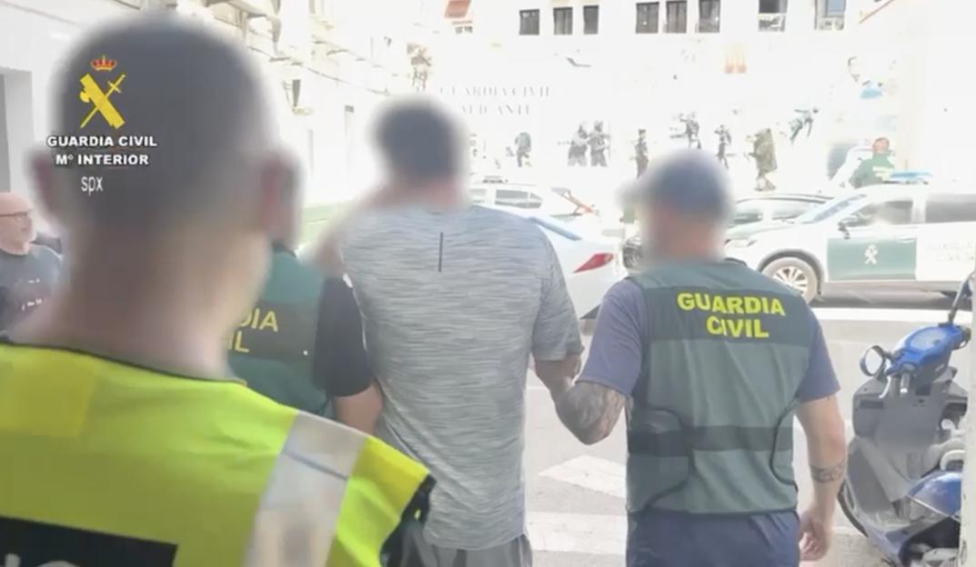 Spanish police arresting Simon Dutton.