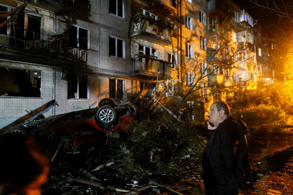 Firefighters work at the site of an apartment building hit by a Russian missile strike in Kyiv