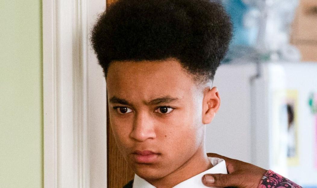 Denzal Danes looking concerned while being touched on the shoulder.