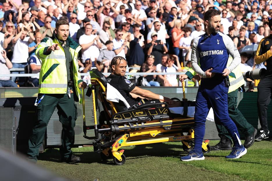Xavi Simons of Tottenham Hotspur is taken away on a stretcher during a Premier League match.