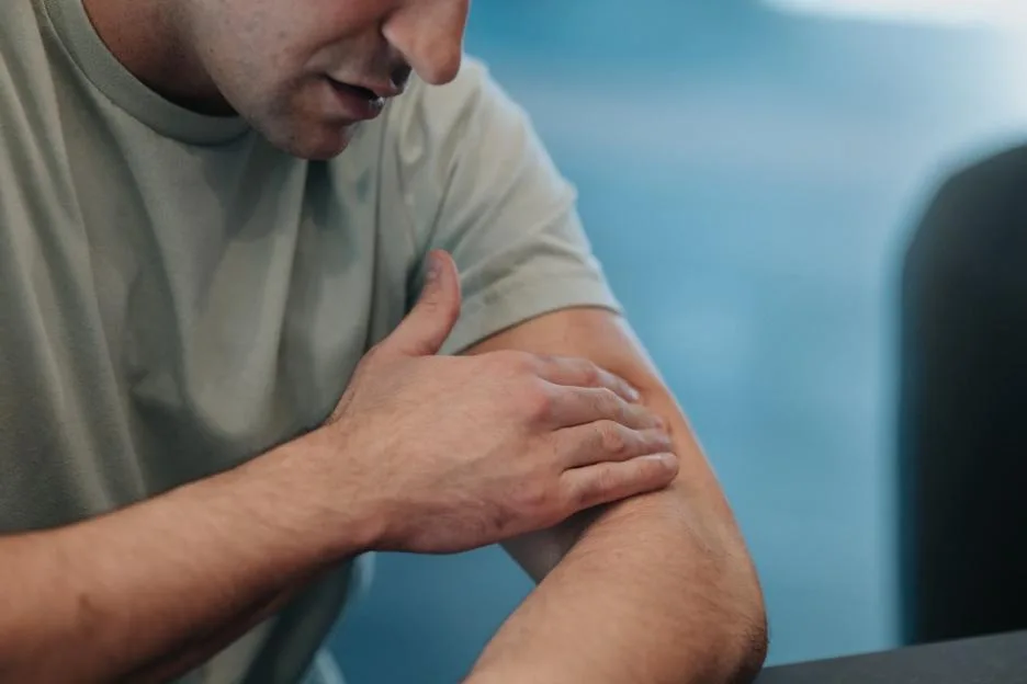 A man applying cannabis topical ointment to his arm.