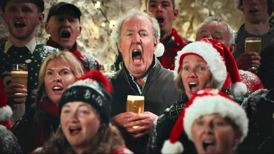 Jeremy Clarkson and the Hawkstone Farmer's Choir singing carols with glasses of beer.