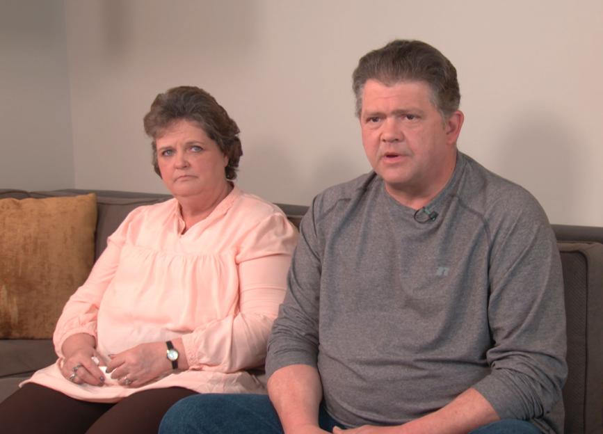 Mickey and Dave Neese, parents of Skylar Neese, sitting on a couch.