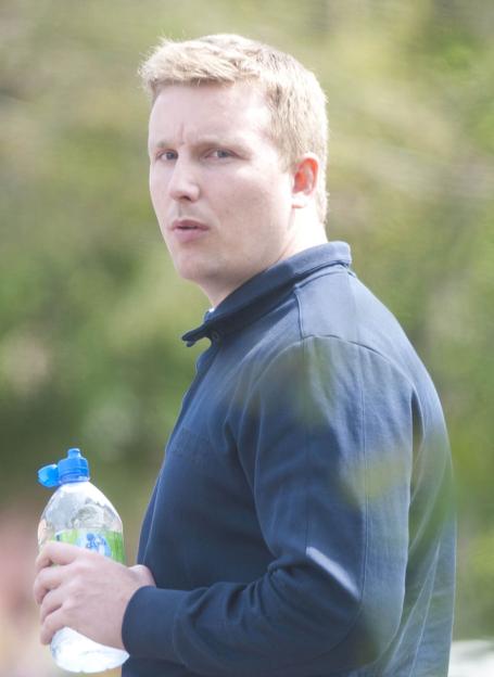 Drug dealer Mark Richardson holding a bottle of water.
