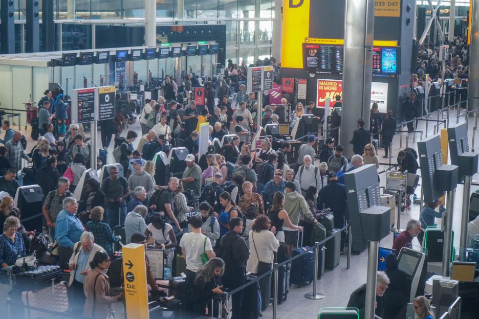 Passengers queue at Heathrow Airport Terminal 2.