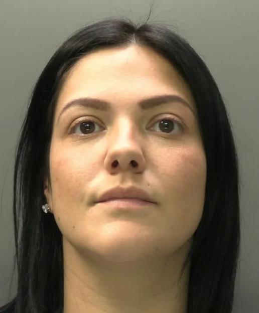 Mugshot of a woman with dark hair looking forward.