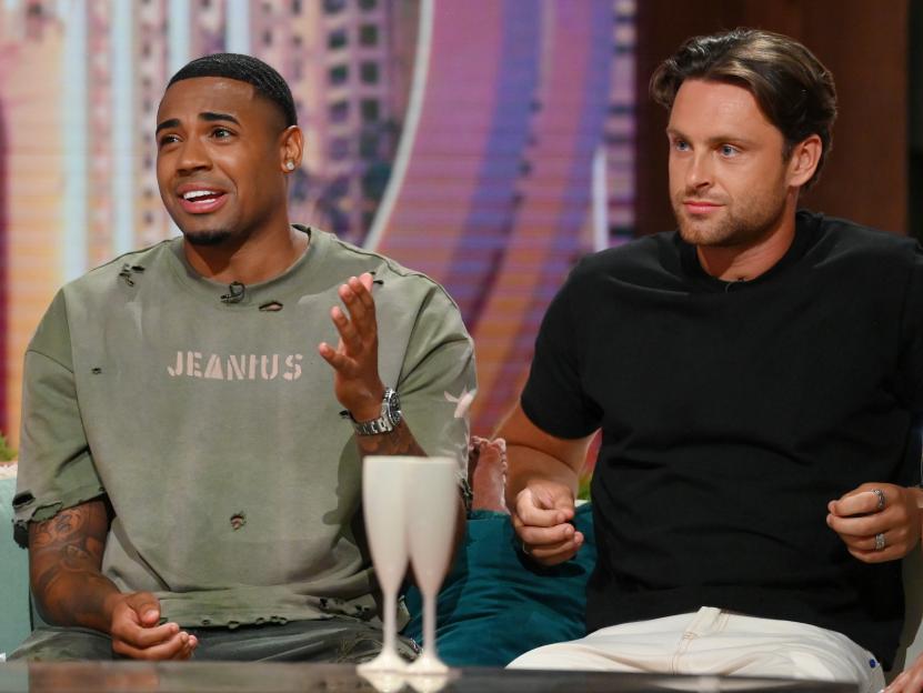 Tyrique Hyde and Casey O'Gorman sitting on a set during the "Love Island Aftersun" TV Show.