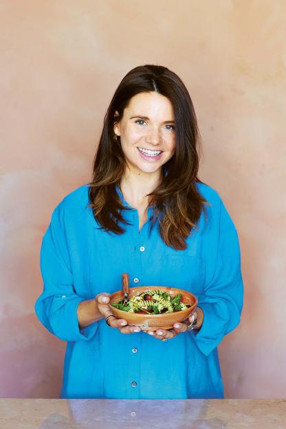 Caroline Hanna holding a bowl of pasta salad.