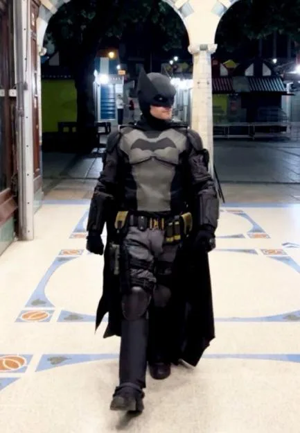 Moment partygoer, 25, dressed as Batman retrieves handbag from wall in UK city after chasing thief through streets