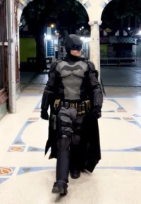 Moment partygoer, 25, dressed as Batman retrieves handbag from wall in UK city after chasing thief through streets