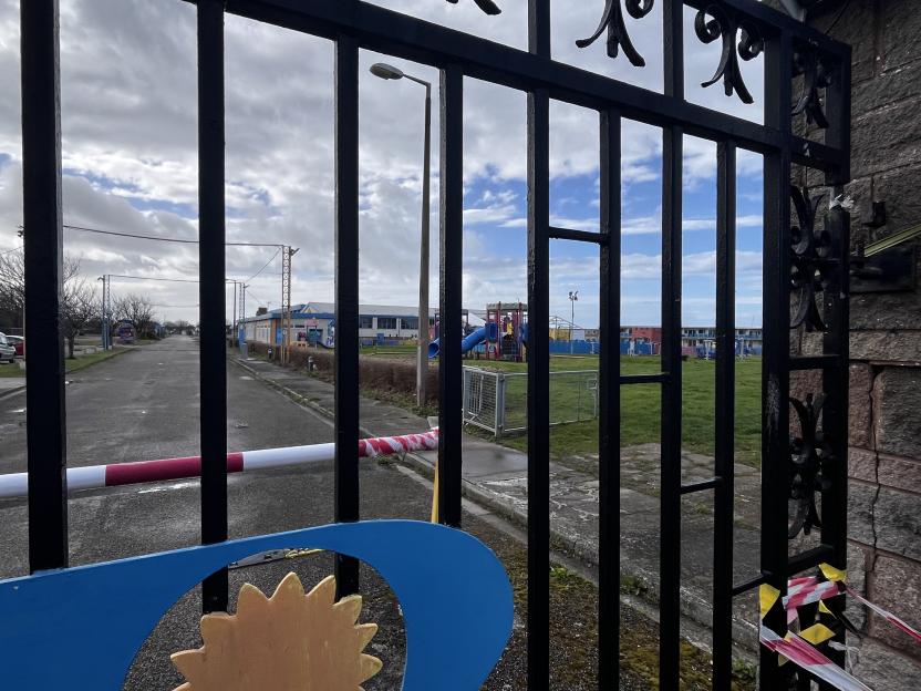 A view of the park at Prestatyn pontins holiday park resort, a young girl gazes over to the park