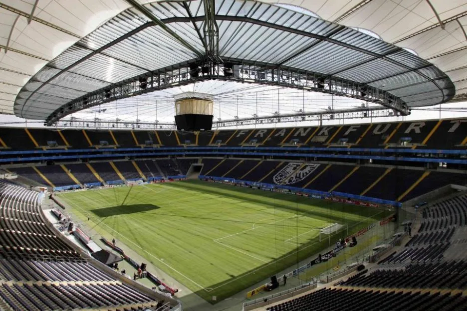 Interior view of the Waldstadion stadium in Frankfurt, showing the pitch and seating under the retractable roof.