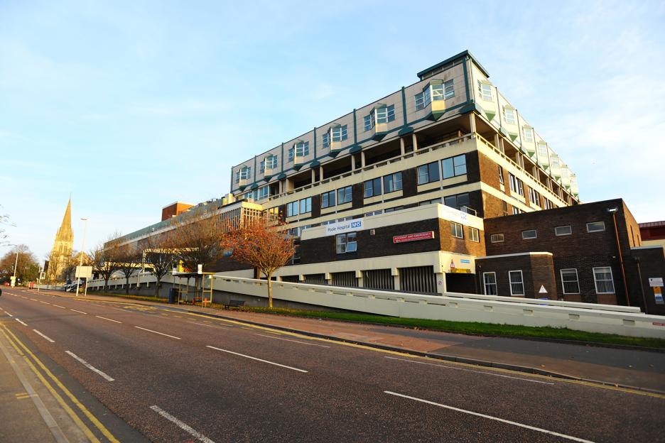 Exterior view of Poole Hospital, a multi-story building with a sign for "Accident and Emergency."