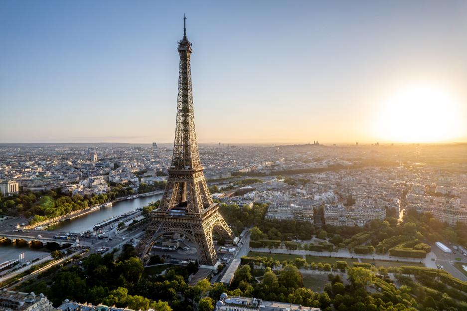 Aerial view of Paris, France, featuring the Eiffel Tower at sunrise.
