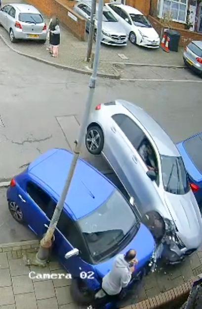 Shocking Scene: Man Flung Across Pavement as Speeding Mercedes Collides with Parked Cars Following Attack on Two Men