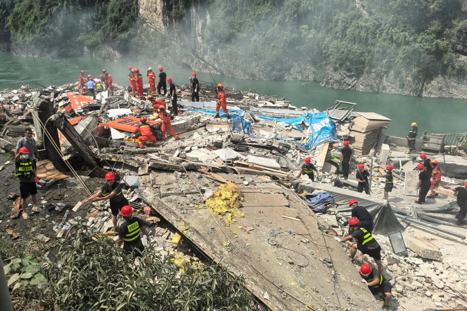 Rescue workers search for survivors at the site of a landslide in Chongqing