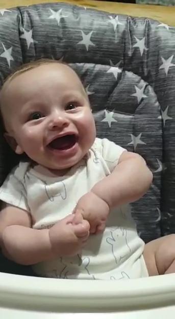 Baby Preston Davey smiling and looking upwards.