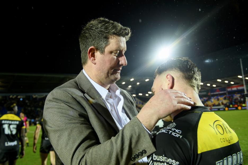 York chairman Clint Goodchild places a hand on the shoulder of a player.