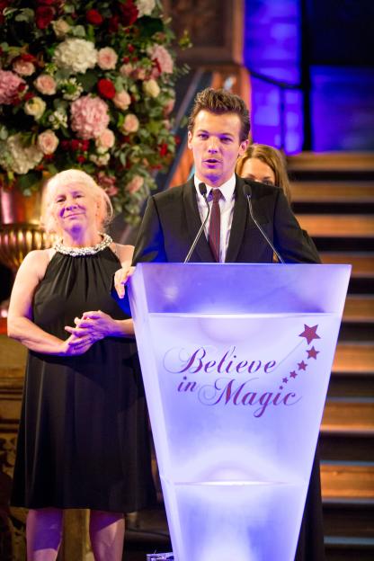 Louis Tomlinson and Jean O'Brien at a lectern at the Cinderella ball.