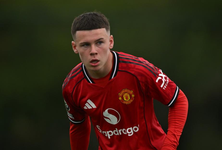 A Manchester United U18 player in a red jersey looking to the right.