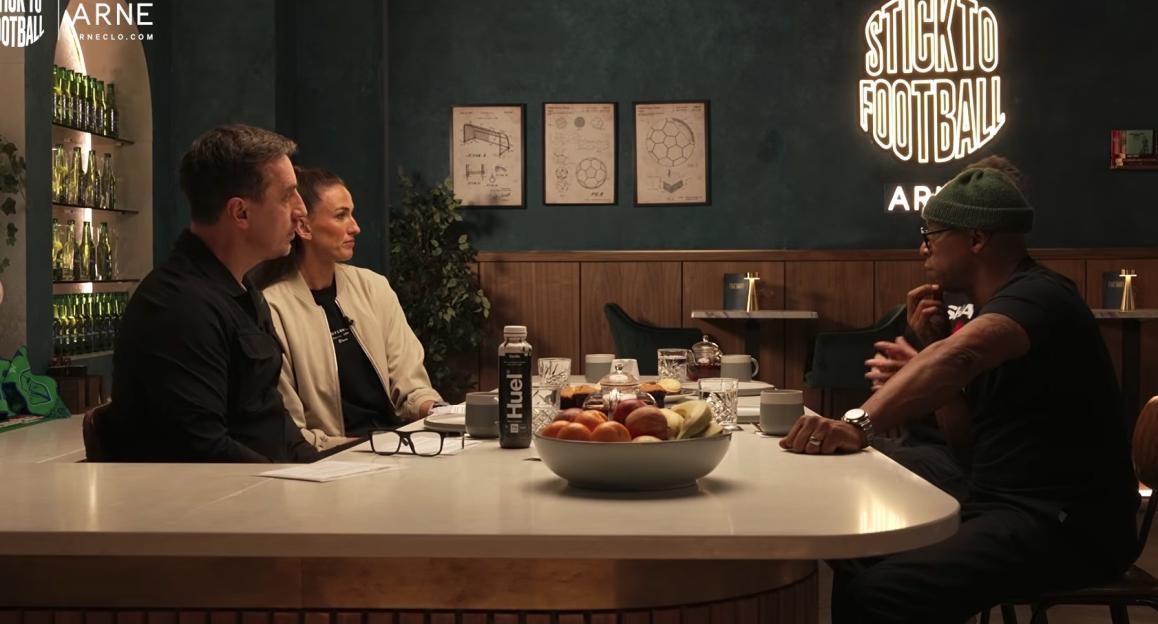 Three people sitting at a table with drinks and snacks.