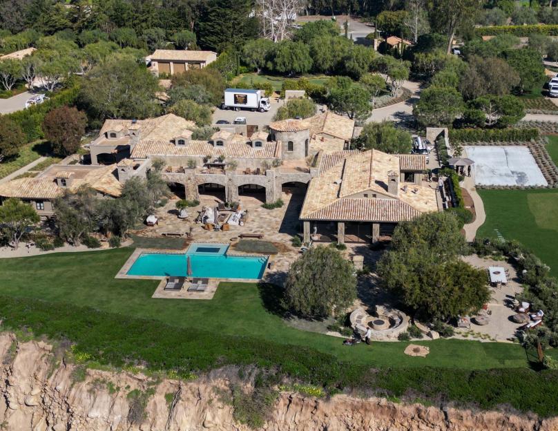 Aerial view of Ellen DeGeneres and Portia de Rossi's Carpinteria home with a pool and a large paved courtyard.