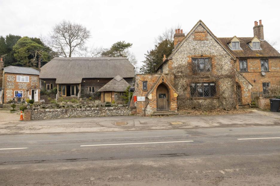 The Crown Inn pub and a barn in Pishill, Oxfordshire, are pictured, both of which appear closed and run down.