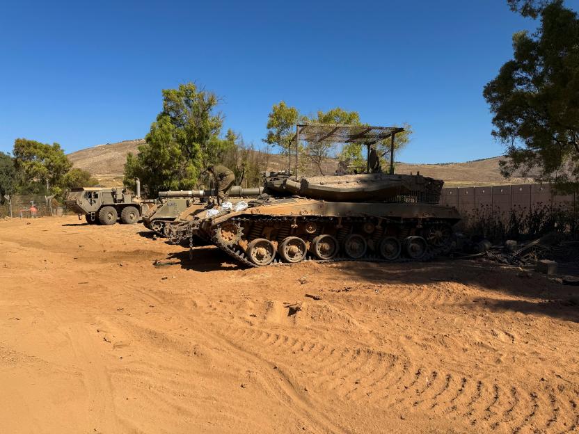 An Israeli soldier works on a tank on the Israeli side of the Israel-Lebanon border