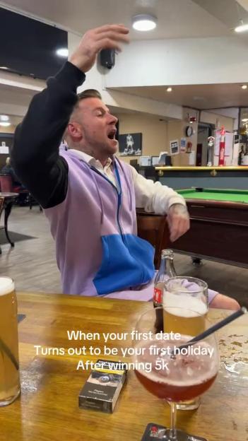 A man excitedly throws his hands up at a bar with drinks and a pool table, with text about a first date leading to a holiday after winning £5k.