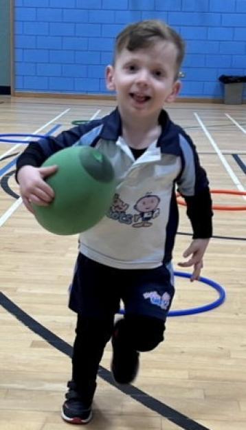Raffi Starkowitz before his cancer diagnosis, holding a green ball.